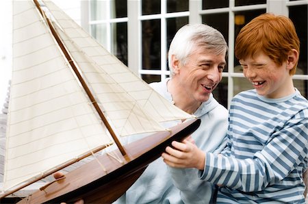family generations caucasian - Senior man and boy holding a model boat, outdoors Stock Photo - Premium Royalty-Free, Code: 6108-05856858