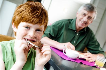 families and chocolate - Senior man and boy having breakfast Stock Photo - Premium Royalty-Free, Code: 6108-05856914