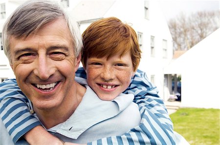 family generations caucasian - Senior man carrying boy on his back in garden Stock Photo - Premium Royalty-Free, Code: 6108-05856928