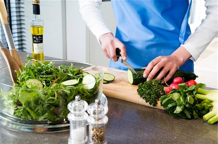 radish dish - Woman making a salad, chopping cucumber, close-up Stock Photo - Premium Royalty-Free, Code: 6108-05857043