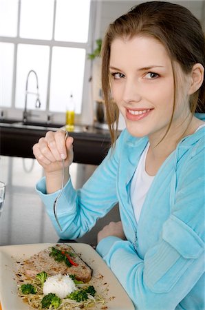 slender woman portrait - Young woman eating meat and rice Stock Photo - Premium Royalty-Free, Code: 6108-05857003