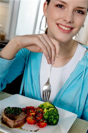 eat meat - Young woman eating meat and vegetables Stock Photo - Premium Royalty-Free, Code: 6108-05857004