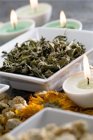 still life with tea - Dried mint and camomile leaves, candles, close-up Stock Photo - Premium Royalty-Free, Code: 6108-05857215