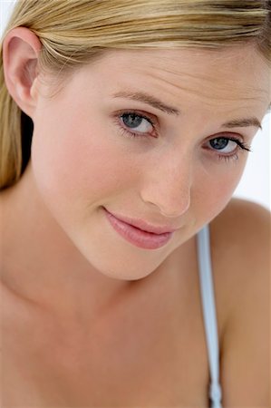 Portrait of young woman frowning Stock Photo - Premium Royalty-Free, Code: 6108-05857347