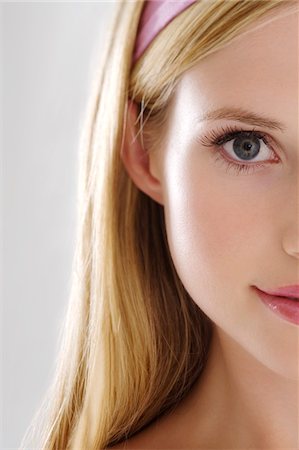 straight hair alice band - Young Woman half face with make up, looking at the camera, close-up, indoors (studio) Stock Photo - Premium Royalty-Free, Code: 6108-05857330