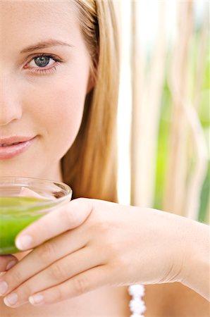 pretty - Portrait of half of a young woman's face, holding  a green tea cup, close-up,  outdoors Stock Photo - Premium Royalty-Free, Code: 6108-05857549