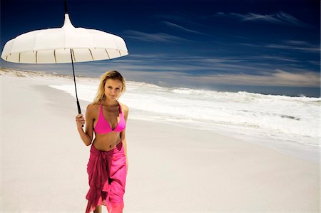 parasol - Young woman in bikini and pareo with parasol on the beach Stock Photo - Premium Royalty-Free, Code: 6108-05857639