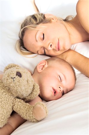 sleeping woman hair - Portrait  mother and her baby sleeping, indoors Stock Photo - Premium Royalty-Free, Code: 6108-05857942