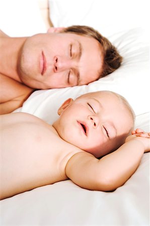 sleeping on bed - Portrait father and baby sleeping, indoors Stock Photo - Premium Royalty-Free, Code: 6108-05857972