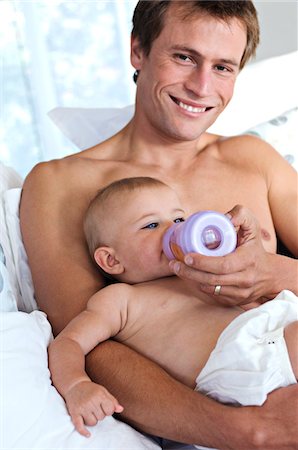 family, meal, baby - Father feeding his baby, indoors Stock Photo - Premium Royalty-Free, Code: 6108-05857979