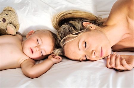 Portrait of a baby and a mother sleeping, indoors Stock Photo - Premium Royalty-Free, Code: 6108-05857992