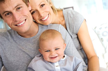 Portrait parents and baby smiling, indoors Stock Photo - Premium Royalty-Free, Code: 6108-05857907