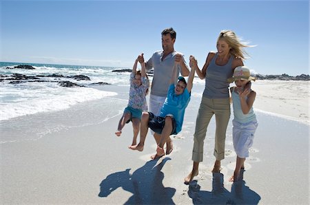 fathers carrying sons on the beach - Parents and three children walking on the beach, outdoors Stock Photo - Premium Royalty-Free, Code: 6108-05858093