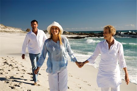 family walk sand - Couple and senior woman on the beach Stock Photo - Premium Royalty-Free, Code: 6108-05858158