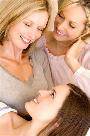 simsearch:6108-05858184,k - Three smiling women looking at each other, indoors Stock Photo - Premium Royalty-Free, Code: 6108-05858166