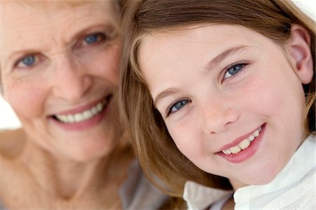 simsearch:6108-05858176,k - Senior woman and little girl smiling for the camera, indoors Stock Photo - Premium Royalty-Free, Code: 6108-05858198