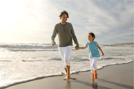 Father and daughter walking on the beach, outdoors Stock Photo - Premium Royalty-Free, Code: 6108-05858135