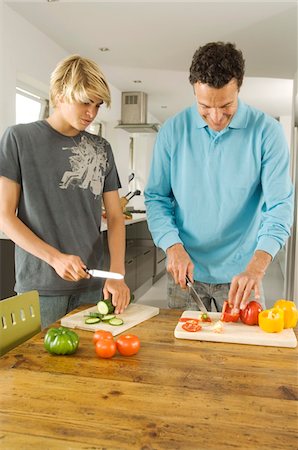 picture of cutting hair - Faher and teenager cooking, indoors Stock Photo - Premium Royalty-Free, Code: 6108-05858273