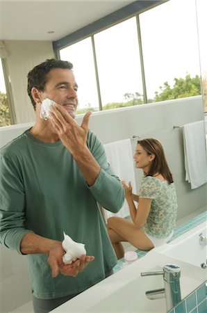 Two men wearing underwear and using sinks in bathroom, Stock Photo