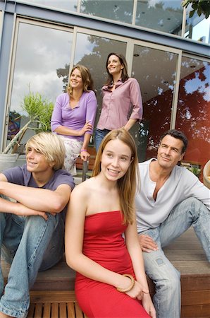 Parents and three teenagers in front of their house, indoors Stock Photo - Premium Royalty-Free, Code: 6108-05858289