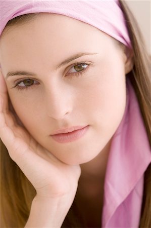 Portrait of a young woman looking at the camera, indoors Stock Photo - Premium Royalty-Free, Code: 6108-05858360
