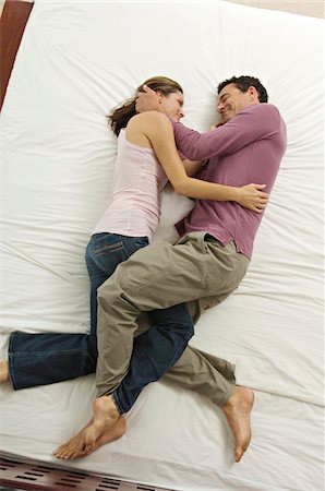 Couple in bed, view from above, indoors Stock Photo - Premium Royalty-Free, Code: 6108-05858316