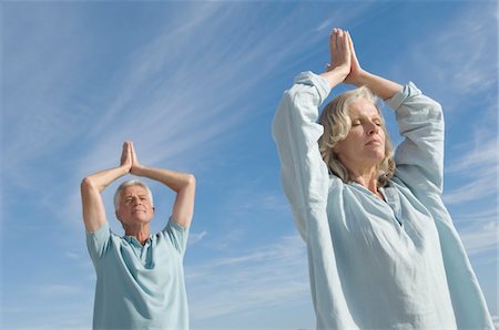 Couple in yoga attitude on the beach, outdoors Stock Photo - Premium Royalty-Free, Code: 6108-05858460