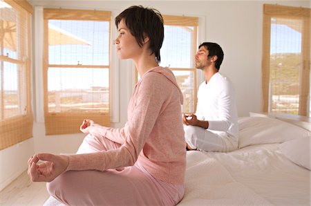 simsearch:6108-05858494,k - Young couple in yoga attitude, indoors Stock Photo - Premium Royalty-Free, Code: 6108-05858473
