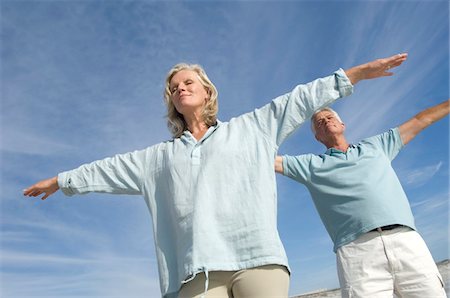 freedom and liberty concepts - Couple in yoga attitude on the beach, outdoors Stock Photo - Premium Royalty-Free, Code: 6108-05858494