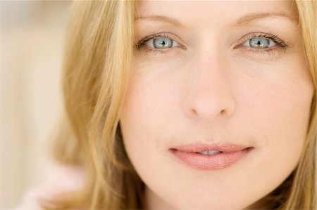 Portrait of a young woman looking at camera Stock Photo - Premium Royalty-Free, Code: 6108-05858415