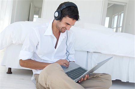 simsearch:6108-05858781,k - Young man using laptop Stock Photo - Premium Royalty-Free, Code: 6108-05858691