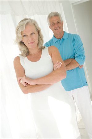 Couple with arms crossed, looking at camera Stock Photo - Premium Royalty-Free, Code: 6108-05858711