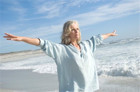 respiring - Woman stretching on the beach Stock Photo - Premium Royalty-Free, Code: 6108-05858736