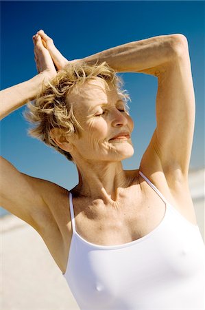 Senior woman doing yoga on the beach Foto de stock - Sin royalties Premium, Código: 6108-05858851