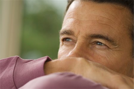 person in white polo shirt - Thoughtful man's portrait, indoors Stock Photo - Premium Royalty-Free, Code: 6108-05858884