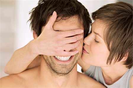 female hands covering eyes - Portrait of young woman kissing man, covering his eyes Stock Photo - Premium Royalty-Free, Code: 6108-05858945