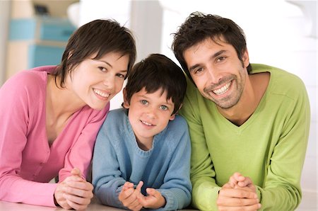 simsearch:6108-05859165,k - Parents and son smiling for the camera, lying on floor Foto de stock - Sin royalties Premium, Código: 6108-05859162