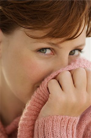 sweater hands - Portrait of young woman covering her face with jumper Stock Photo - Premium Royalty-Free, Code: 6108-05859105