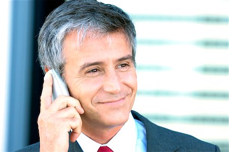 Mature businessman using mobile phone, close-up Stock Photo - Premium Royalty-Free, Code: 6108-05859246