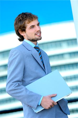 simsearch:6108-05859384,k - Young businessman holding file, side view Stock Photo - Premium Royalty-Free, Code: 6108-05859264
