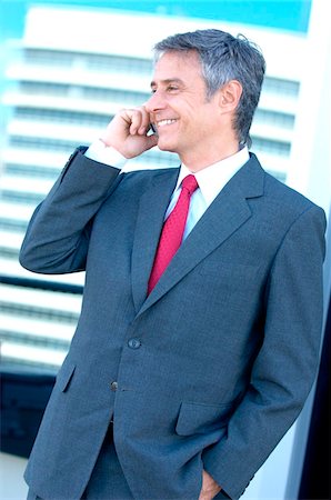 simsearch:6108-05859331,k - Businessman using mobile phone, smiling Stock Photo - Premium Royalty-Free, Code: 6108-05859238