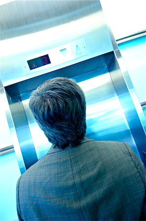 simsearch:6108-05859384,k - Businessman waiting by elevator, rear view Stock Photo - Premium Royalty-Free, Code: 6108-05859368