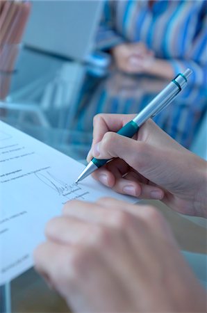 pen on desk - Person signing on document, close-up Stock Photo - Premium Royalty-Free, Code: 6108-05859450