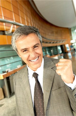 simsearch:6108-05859384,k - Mature businessman smiling in office, portrait Stock Photo - Premium Royalty-Free, Code: 6108-05859419