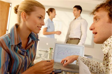 phone blonde woman at desk - Businesspeople discussing in office Stock Photo - Premium Royalty-Free, Code: 6108-05859516