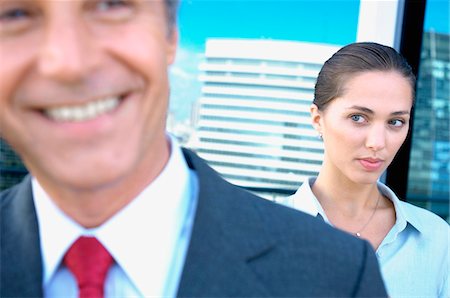 simsearch:6108-05859384,k - Businesswoman staring at businessman in office Stock Photo - Premium Royalty-Free, Code: 6108-05859616