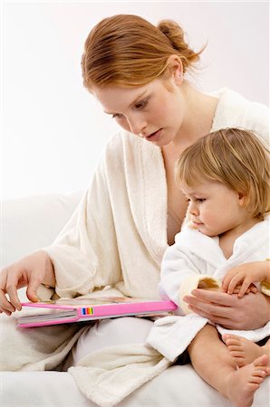 simsearch:400-07712720,k - Close-up of a young woman sitting with her baby boy and looking at a picture book Stock Photo - Premium Royalty-Free, Code: 6108-05860196