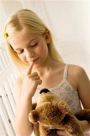 Girl holding a teddy bear Stock Photo - Premium Royalty-Free, Code: 6108-05860296