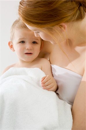 drying - Close-up of a young woman wrapping her son in a towel Stock Photo - Premium Royalty-Free, Code: 6108-05860208