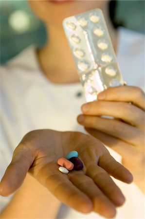 Close-up of pills on a doctor's palm Stock Photo - Premium Royalty-Free, Code: 6108-05860346